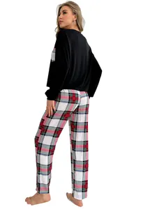 Side-back view of women's black long-sleeve top and red plaid pajama set for fall winter