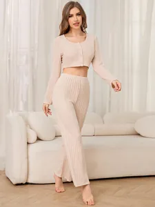 Detailed full view of beige ribbed long-sleeve crop top and wide-leg trousers set