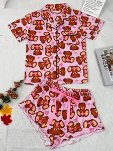 Cute pink two-piece pajama set featuring cartoon teddy bear and heart patterns for summer
