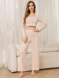 Detail shot of a beige ribbed loungewear set with button-up top and wide-leg pants