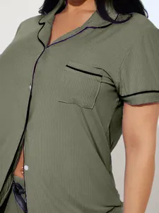 Close-up detail of women's olive green ribbed pajama top with lapel and pocket