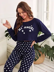 Detail of navy blue two-piece pajama set featuring white star patterns and crop top