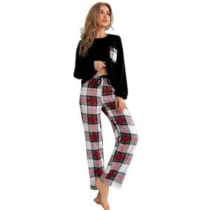 Two-piece women's plaid pajama set with black long-sleeve top and patterned pants