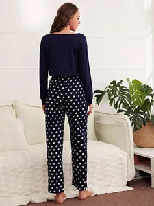 Rear view of long-sleeve crop top and navy blue star print pajama pants loungewear set