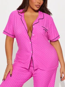 Women's pink polka dot pajama set featuring a short sleeve button shirt and long pants