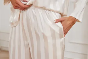Detail view of striped satin pajama pants with side pocket for women's comfort loungewear