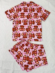Pink short-sleeved pajama set with cartoon bear and heart pattern flat lay view