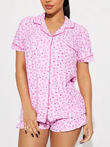 Close-up of pink women's two-piece pajama set with heart print and lapel collar