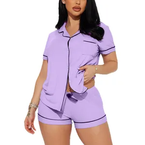 Women's two-piece purple ribbed pajama set with black piping details, shorts and shirt
