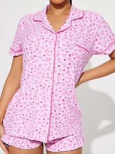 Close-up detail of women's pink heart print pajama set with button-down collar