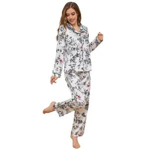 Women's floral satin pajama set featuring long-sleeve top and pants in elegant white