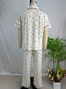 Back view of women's white pajama set featuring red cherry print and short sleeves.