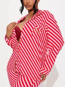 Detailed view of women's red and pink diagonal striped pajama set with blessed embroidery