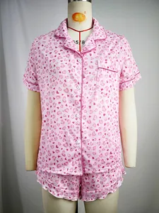 Detail view of women's pink short sleeve pajama set with heart print on a dress form