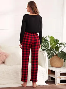 Back view of women's lounge set featuring black long sleeve top and red plaid pants
