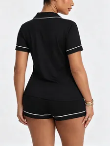 Rear view of women's black modal pajama set featuring elegant white contrast piping detail