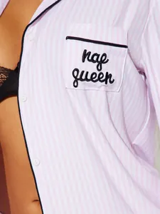 Close-up of pink striped pajamas with 'nap queen' embroidery on the pocket