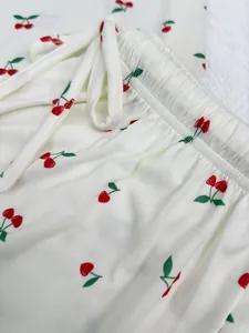 Detailed view of women's cherry print pajama pants showing the drawstring waistband