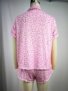 Back view of women's pink heart print short sleeve pajama top and shorts set on mannequin