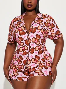 Close-up of pink two-piece pajama set with cartoon teddy bear and heart print