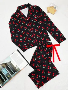 Detailed view of women's black cherry print long sleeve pajama set