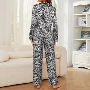 Elegant leopard print two-piece pajama set with long sleeves and pants in a home setting