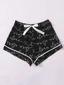 Black women's pajama shorts with white love store script print and satin bow detail