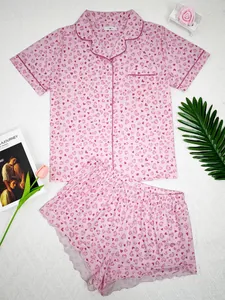Detailed view of women's pink heart print pajama set with lapel shirt and shorts