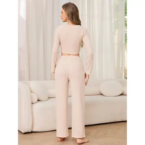 Beige ribbed two-piece loungewear set with long sleeve crop top and wide leg pants