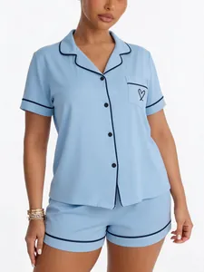 Two-piece light blue women's summer pajama set with short sleeves and heart pocket detail