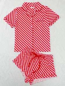 Detailed view of red and pink diagonal striped two-piece pajama set with ruffle trim