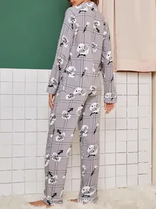 Back view of women's long-sleeve pajama set with gray floral and grid print