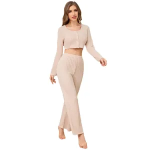 Two-piece beige ribbed loungewear set featuring long-sleeve crop top and wide-leg pants