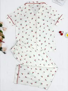 Detail of the cherry print and red piping on these women's two-piece short sleeve pajamas.