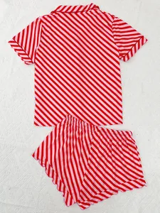 Detailed view of red and pink diagonal striped women's pajama set on a white fabric.