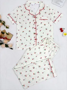 Two-piece cherry print pajama set with short sleeve lapel top and matching long pants.
