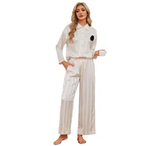 Elegant striped silk-like pajama set for women, long sleeves and pants in light beige.