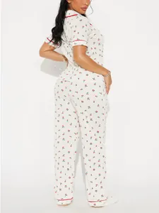 Two-piece cherry print pajama set featuring short sleeve shirt and long pants detail view