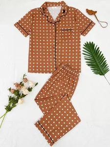 Comfortable two-piece polka dot pajama set with short-sleeved top and long pants laid flat