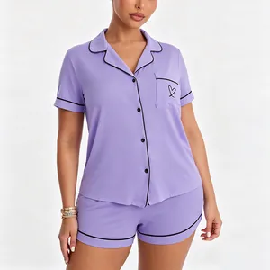 Close-up detail of women's purple modal pajama set featuring black piping and heart embroidery