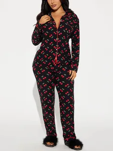 Full view of black long-sleeved pajama set with red cherry prints and piping details.