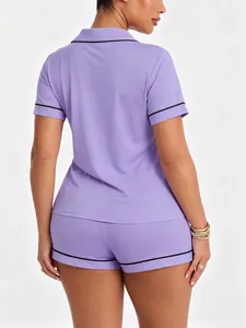 Back view of women's purple short sleeve pajama set with elegant black piping detail