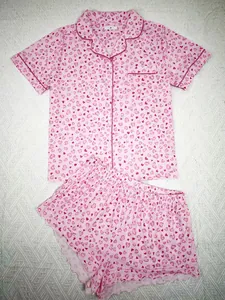 Close-up of pink heart-print pajama set with button-down shirt and shorts