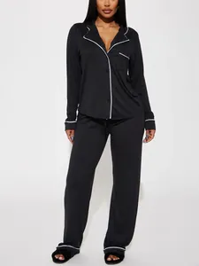 Détail du pyjama deux pièces noir pour femme avec liseré contrasté blanc élégant.