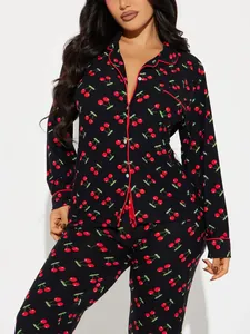 Women's two-piece black pajama set with vibrant red cherry print and red piped lapels
