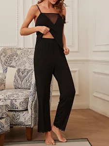 Elegant women's black pajama set featuring a mesh lace camisole and long trousers