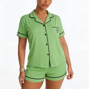 Front view of women's lime green modal pajama set with black piping and heart pocket