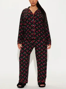 Women's two-piece black nightwear set featuring red cherry print and piping detail