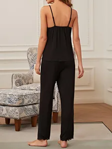 Full back view of a black sleeveless camisole and pants pajama set with lace trim