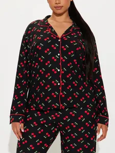 Detail view of plus size black cherry print pajama set featuring red piping and lapel collar